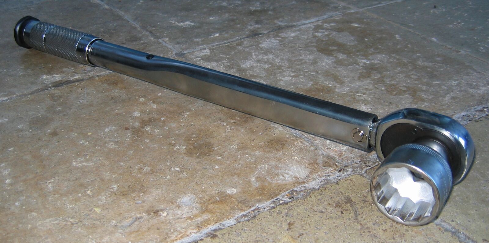 Click torque wrench with a socket on the square drive